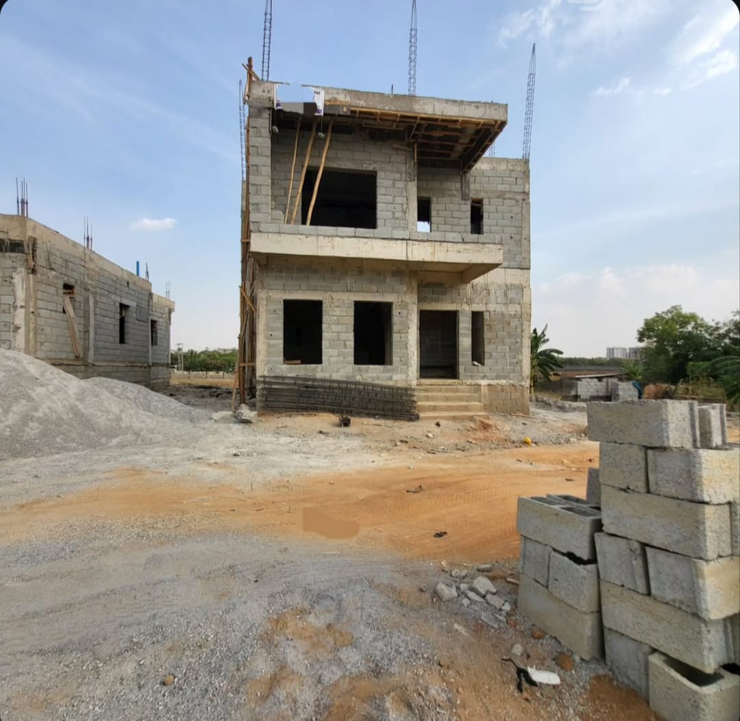 A two-storey shell rises, block by block.