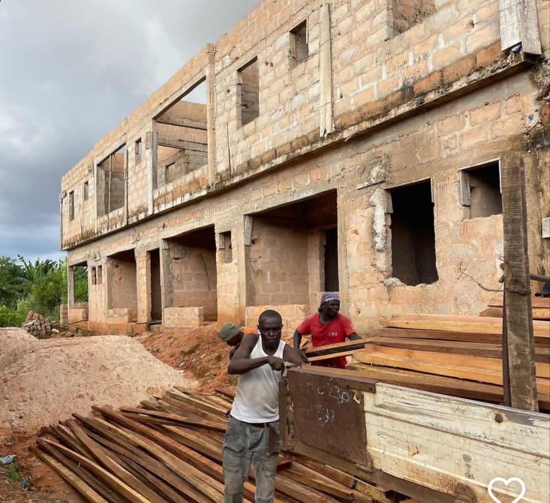 Materials moved into position along a row of units under construction.