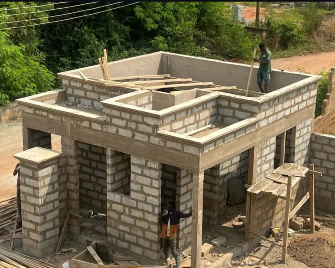 Roof-level block work nearing completion, viewed from above.