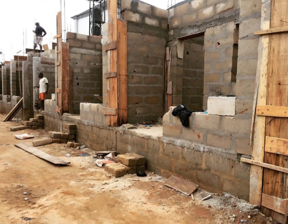 Column formwork braces a terrace block under construction.