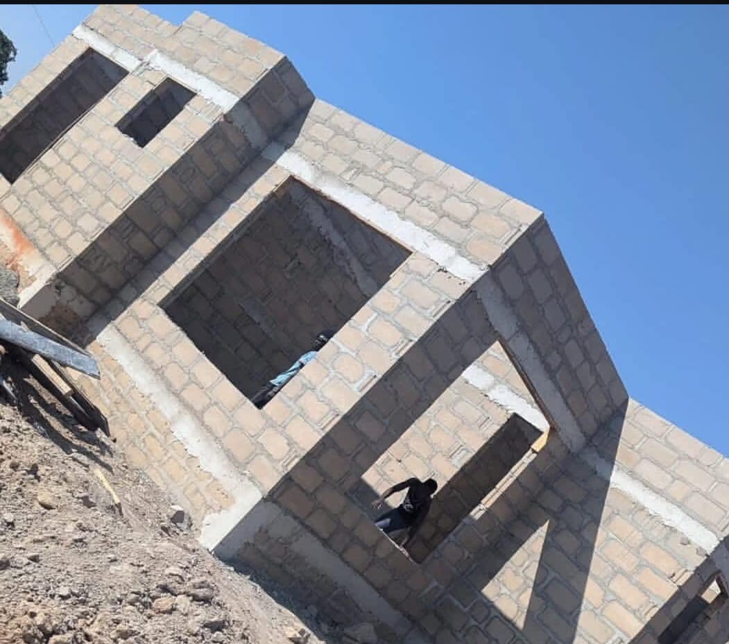 Block walls climbing toward roof level.